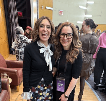 Suzy Welch and Lindsey Pollack standing together at a conference